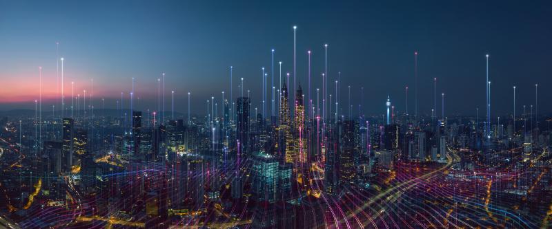 Cityscape at night with overlay of light beams