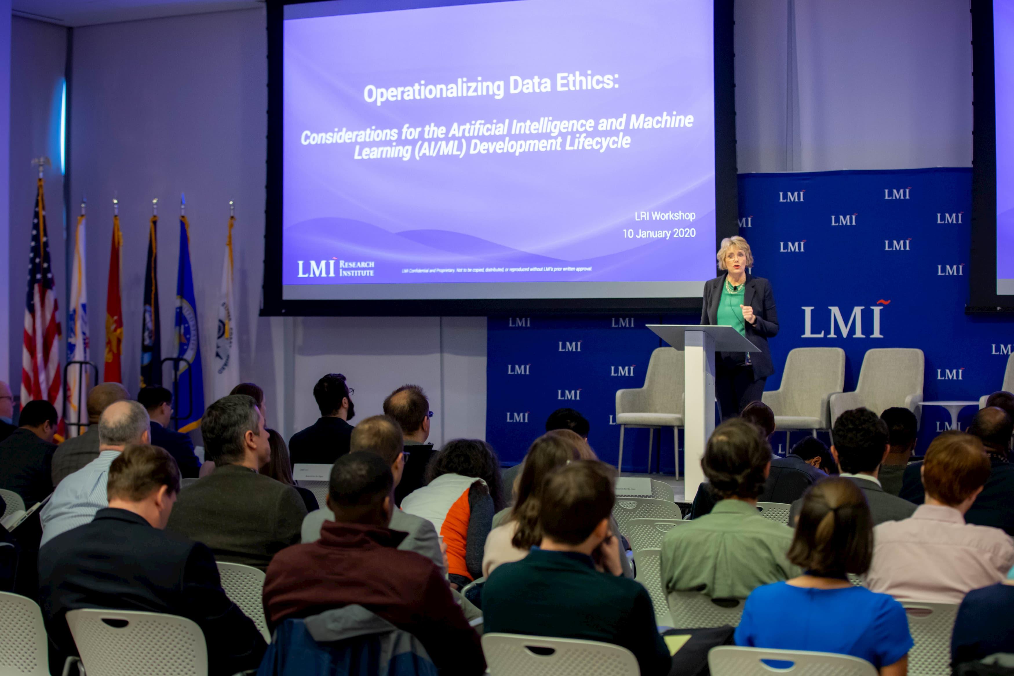 Linda Bixby in front of a presentation screen reading Operationalizing Data Ethics: Considerations for the Artificial Intelligence and Machine Learning (AI/ML) Development Lifecycle, LRI Workshop, 10 January 2020, LMI Research Institute