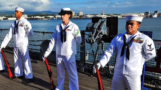 A diverse group of sailors standing at attention