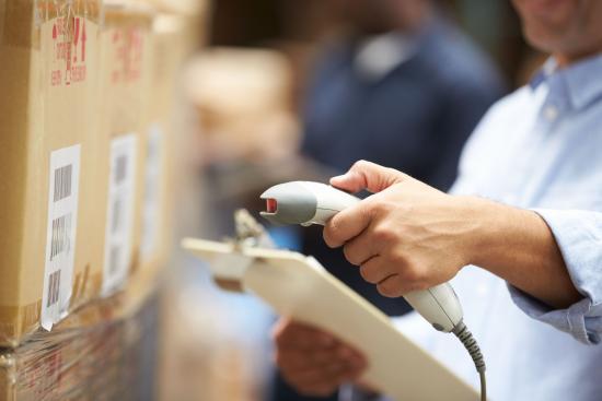 A worker using a scanner to check inventory